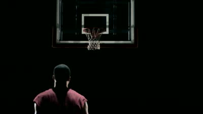 stock-footage-behind-shot-of-basketball-player-shooting-hoops